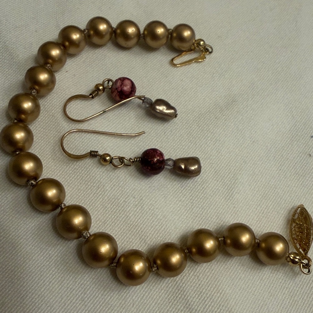 Macy's Gold Beaded Bracelet and Pink Earring Set. 1 earring tiny tarnish spot.